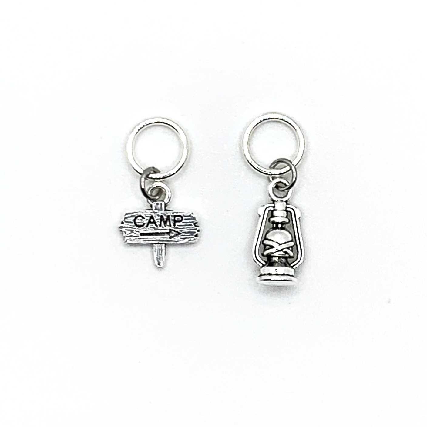 Two antiqued silver stitch markers, one camping sign and one lantern for knitting by Pretty Warm Designs