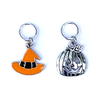 Two Hallowe'en-themed knitting ring stitch markers, one orange and black enamel witch hat and one silver toned jack-o-lantern by Pretty Warm Designs