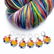 Set of six yellow and rainbow petal enamel happy face flower charms snag free ring stitch markers with variegated yarn for knitting by Pretty Warm Designs