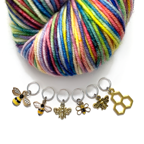 Set of six gold toned bee themed charms snag free ring stitch markers with multicoloured yarn for knitting by Pretty Warm Designs