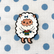 White and multicoloured enamel on black background sweater knitting sheep brooch pin on blue polka dot fabric bag by Pretty Warm Designs
