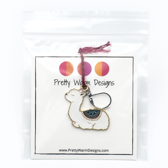 White, pink, teal and dark red enamel on gold toned background with silver plated lever back clasp crochet locking stitch marker attached by yarn to cardstock with logo and text in plastic zip bag by Pretty Warm Designs