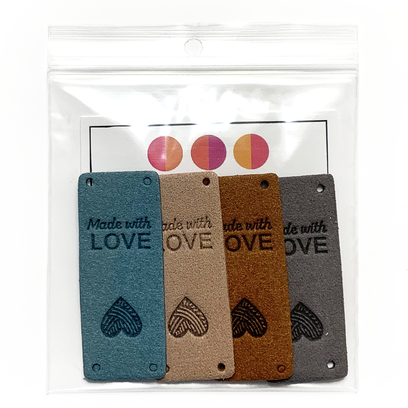 Four teal, tan, medium brown and grey coloured PU polyurethane vegan leather garment label tags for knitted and crocheted items packaged in a clear zip polybag and sold by Pretty Warm Designs Inc.