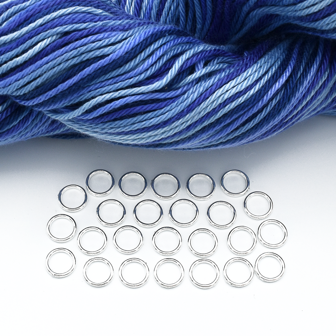 Set of 25 medium silver ring snag free stitch markers with blue yarn for knitting by Pretty Warm Designs