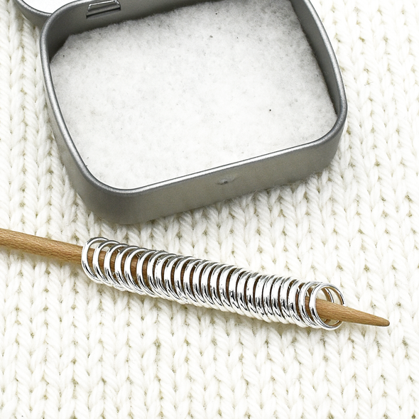 Set of 25 medium silver ring snag free stitch markers with tin on knitting needle by Pretty Warm Designs