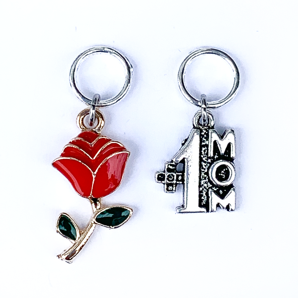 Two Mother's Day-themed knitting ring stitch markers, one red and green enamel rose and one silver #1 Mom by Pretty Warm Designs