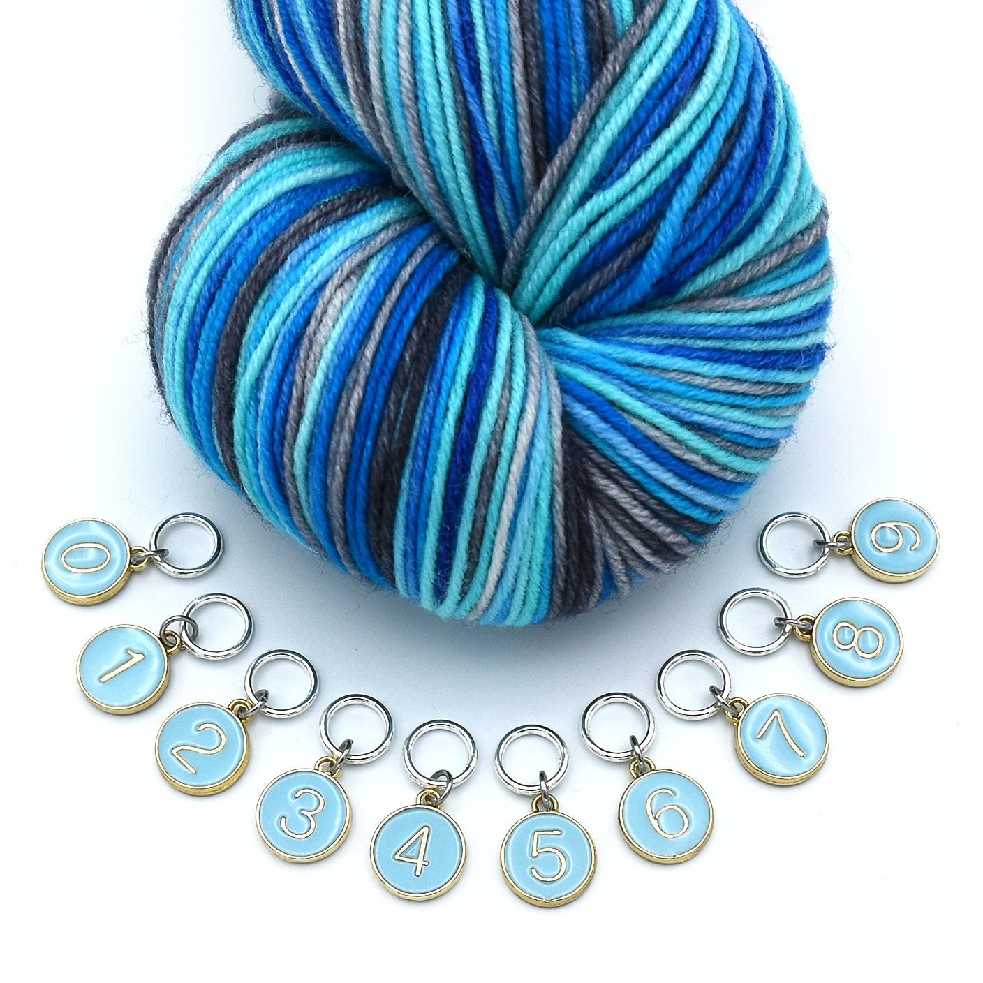 Set of ten blue on gold-toned number charm ring stitch markers with variegated yarn in blue colours for knitting by Pretty Warm Designs
