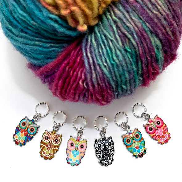 Set of six multi-coloured enamel owl charm snag free ring stitch markers with variegated teal, pink, purple, gold and red yarn for knitting by Pretty Warm Designs