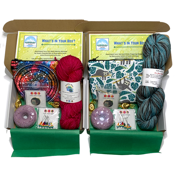 Box containing skein of hand dyed yarn, zipper pouch, enamel pin, purple bath bomb, knitting stitch markers, Werther's Candies, folded paper insert for the Pacific Northwest Mystery Yarn Boxes by Pretty Warm Designs