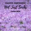 Logo depicting a field of purple crocuses for the Pacific Northwest Not Just Socks Yarn Box sold by Pretty Warm Designs Inc.
