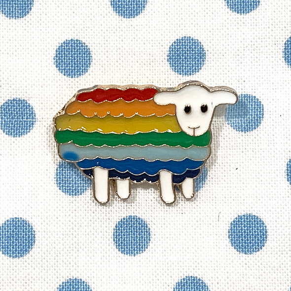 Rainbow striped enamel on metal sheep pin on blue polka dot fabric project bag by Pretty Warm Designs
