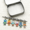 Set of six multi coloured enamel robot charms snag free ring stitch markers with tin on needle for knitting by Pretty Warm Designs