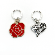 Two Valentine's Day themed knitting ring stitch markers, one red rose and one Tibetan antiqued silver filigree heart by Pretty Warm Designs
