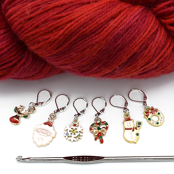 Set of six different Christmas themed charms locking stitch holders with hook and red yarn for crochet by Pretty Warm Designs