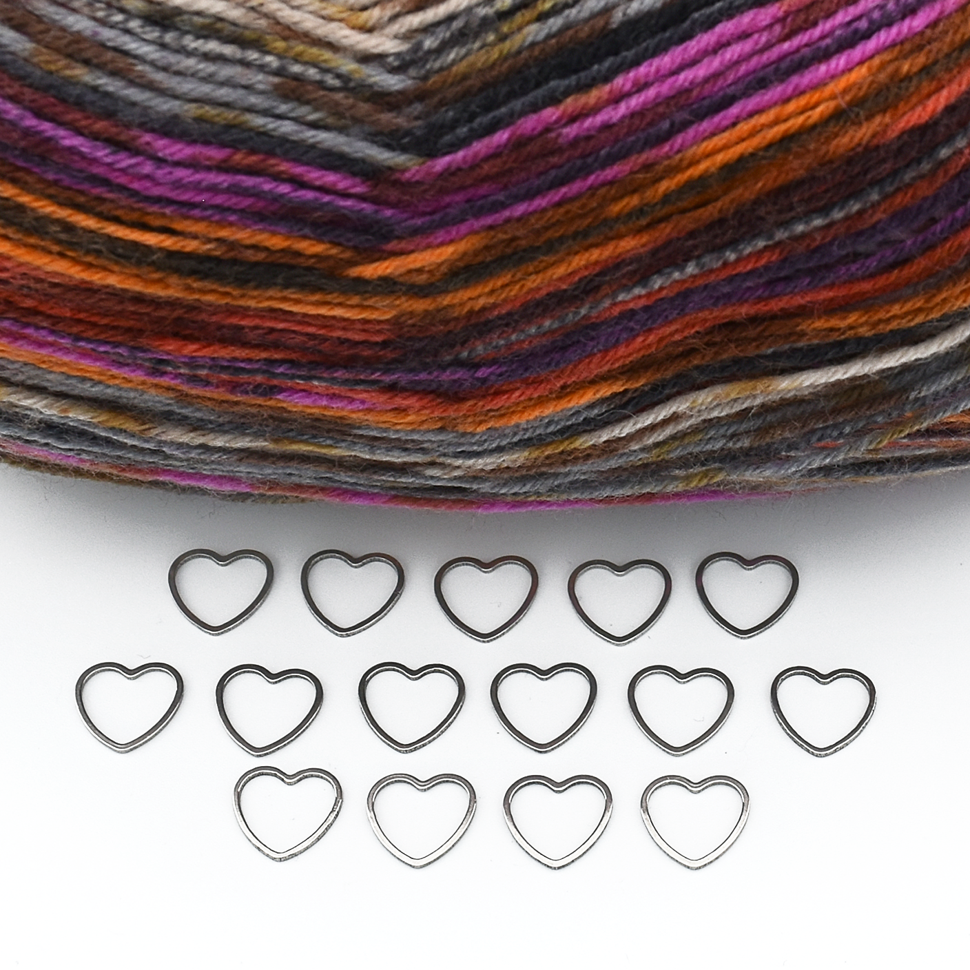 Set of fifteen small heart silver toned ring stitch markers with multi coloured variegated yarn for knitting by Pretty Warm Designs