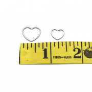 Large and small heart silver toned ring knitting stitch markers above measuring tape by Pretty Warm Designs