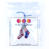 Two red, white and blue or black enamel socks knitting ring stitch markers by Pretty Warm Designs packaged with cardstock and a logo in a poly bag