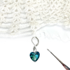Faceted blue heart charm locking crochet stitch marker with crochet hook and crocheted lace by Pretty Warm Designs Inc.