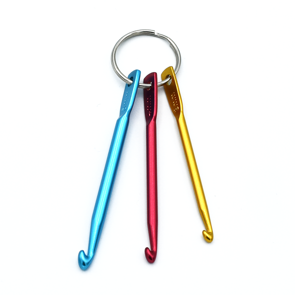 Set of three aluminum crochet hook stitch fixers in sizes 3mm in gold, 4mm in red and 5mm in turquoise on split ring for knitting by Pretty Warm Designs