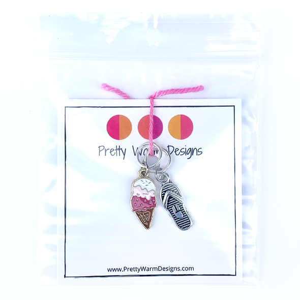 Two summer-themed knitting ring stitch markers, one pink and brown enamel ice cream cone and one silver toned flip flop attached with yarn to cardstock with Pretty Warm Designs text and logo in a poly bag