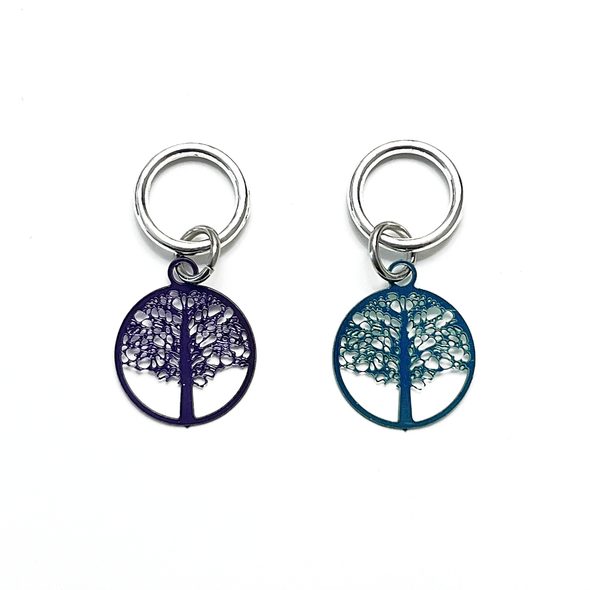 Two purple and turquoise colour coated stainless steel round charm snag free knitting stitch markers by Pretty Warm Designs Inc