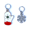Two Winter-themed knitting ring stitch markers, one red, white and green enamel mitten and one silver toned snowflake with rhinestones by Pretty Warm Designs